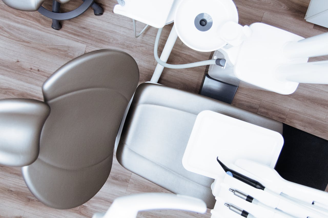 who-we-are High-angle view of a modern dental chair and equipment setup in a professional clinic.
